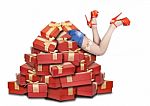 Woman's Legs Sticking Out From A Pile Of Gifts Stock Photo