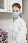 Women Doctor With Face Mask In The Office Stock Photo