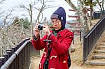 Women In Red Coat Taking A Photo At Japan Garden Stock Photo