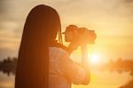 Women Nature Photographer With Digital Camera On The Mountain Stock Photo