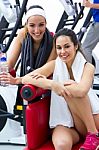 Women Relaxing In The Gym After Making Exercise Stock Photo