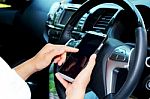 Women Using Smart Phone In The Car Stock Photo