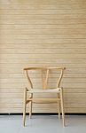 Wooden Chair With Wooden Wall In Background Stock Photo