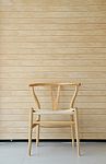 Wooden Chair With Wooden Wall In Background Stock Photo