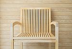 Wooden Chair With Wooden Wall In Background Stock Photo