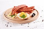Wooden Chopping Board With Sausages, Cheese, Bread Stock Photo