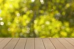 Wooden Floor With Blur Natural Green Bokeh Stock Photo