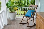 Wooden Rocking Chair On Front Porch Stock Photo