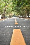 Words Of Keep Trying With Yellow Line Marking On Road Surface In The Park Stock Photo
