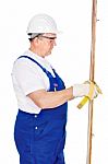 Worker Measuring The Board Stock Photo