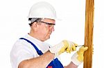 Worker Screwing Nail In Board Stock Photo