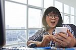 Working Woman Looking To Smart Phone With Amazing Happiness Face In Working Office Room Stock Photo