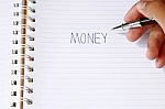 Write The Word Money With Pen In Blur Man's Hands Stock Photo