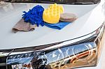 Yellow, Green Sponges And Blue Mitts For Washing And Microfiber Fabric With Cleaner Cloth On White Car Stock Photo