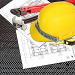 Yellow Helmet Of Labor Constructor With Blueprints Building Stock Photo