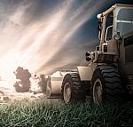 Yellow Tractor In A Field Stock Photo