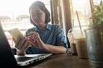Young Asian Woman Working In Coffee Shop Stock Photo