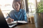 Young Asian Woman Working In Coffee Shop Stock Photo