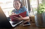 Young Asian Woman Working In Coffee Shop Stock Photo