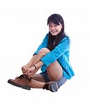 Young Beautiful Asian Woman Sitting And Wearing Her Shoes Stock Photo