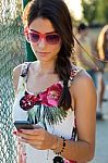 Young Beautiful Girl Texting With Her Phone Stock Photo