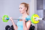 Young Beautiful Strong Blond Woman With Barbell And Weight Plate Stock Photo