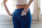 Young Beautiful Woman At Home With Mobile Phone In Back Pocket Stock Photo