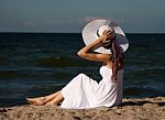 Young Beautiful Woman In A White Dress On The Beach Stock Photo