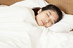 Young Beautiful Woman Sleeping In Bed Stock Photo