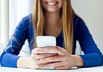 Young Beautiful Woman Using Her Mobile Phone At Home Stock Photo
