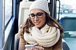 Young Beautiful Woman Using Her Mobile Phone On A  Bus Stock Photo