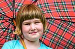 Young Blonde Girl Under Umbrella In Rain Stock Photo