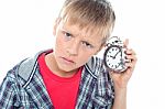 Young Boy Holding Alarm Clock Stock Photo
