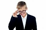 Young Boy Removing Eyeglass Stock Photo