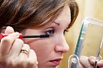 Young Brunette Tints Her Eyes Stock Photo