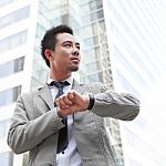 Young Businessman Looking At His Wristwatch Stock Photo