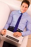 Young Businessman Lying Couch Using Laptop Stock Photo