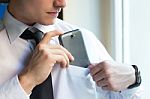 Young Businessman Using His Mobile Phone In Office Stock Photo