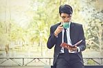 Young Businessmen Are Looking At Report Paper And Holding A Cup Stock Photo