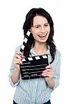Young Charming Girl Holding Clapperboard Stock Photo