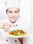 Young Chef Decorating Delicious Salad Stock Photo