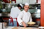 Young Chef Making Pizza At Kitchen Stock Photo