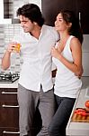 Young Couple In Kitchen Stock Photo