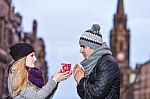 Young Couple In Love Sharing A Cup Of Hot Drink On A Cold Winter Stock Photo
