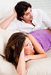 Young Couple Lying In Couch Stock Photo