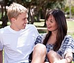 Young Couple Sitting Together Stock Photo