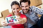 Young Couple  Taking Selfies In Their New Home Stock Photo