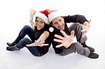 Young Couple Wearing Christmas Hat With Hand Gesture Stock Photo