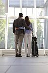 Young Couple With Luggage Waiting At Airport Stock Photo