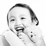Young Cute Girl Hugging A Teddy Bear Stock Photo